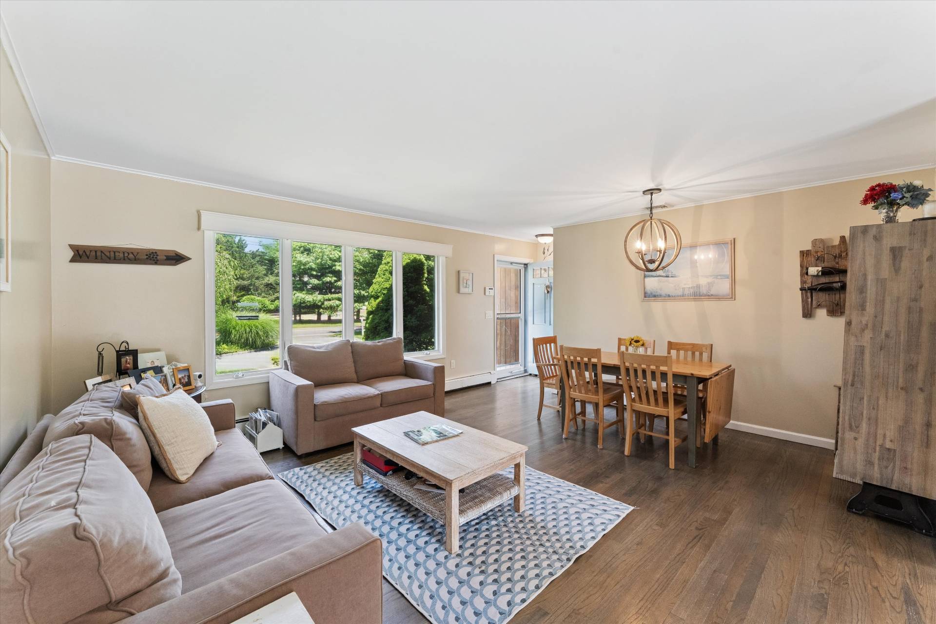 27 South Country Road Westhampton, NY 11977 - Photo 3 of 16 a living room with furniture a wooden floor and a window