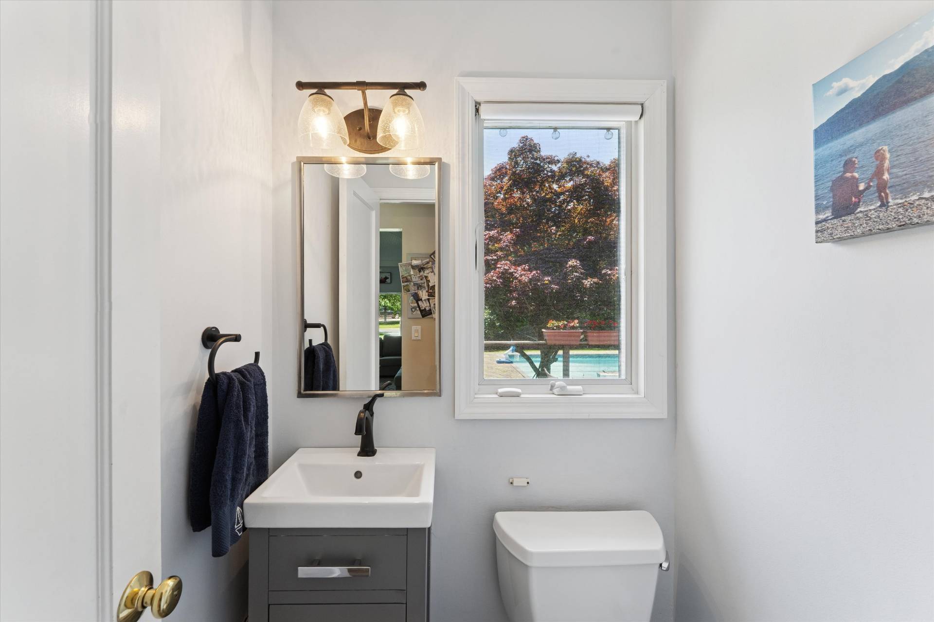 27 South Country Road Westhampton, NY 11977 - Photo 7 of 16 a bathroom with a sink a toilet and mirror