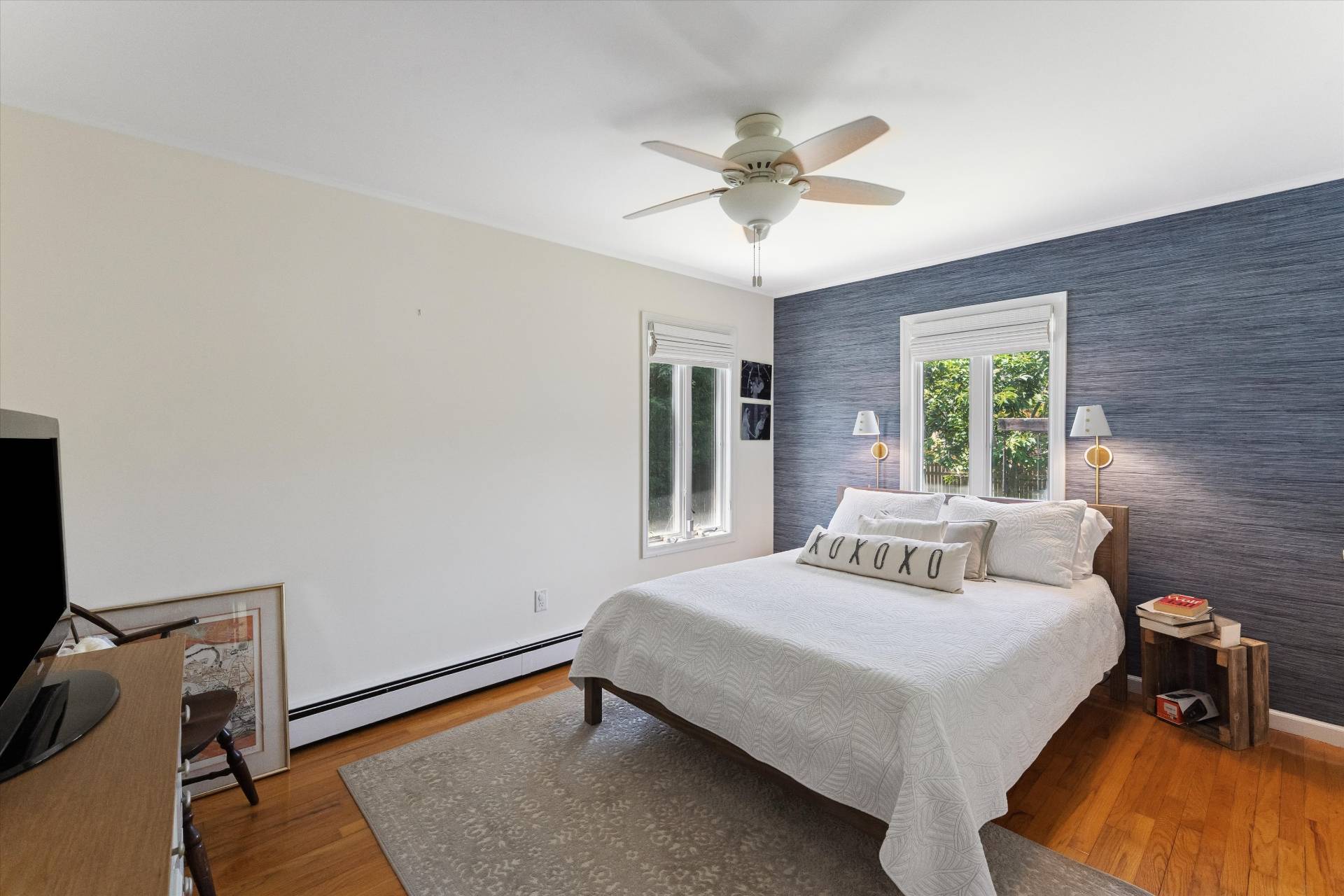 27 South Country Road Westhampton, NY 11977 - Photo 8 of 16 a bedroom with a bed and a chandelier