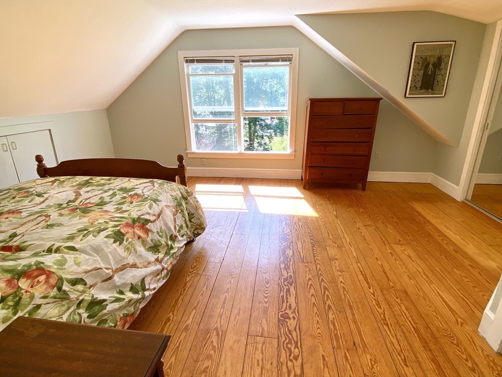 14 Nutting Avenue Amherst, MA 01002 - Photo 31 of 41 a bedroom with a bed and wooden floor