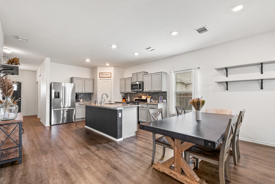 136 Copper Lane Kyle, TX 78640 - Photo 12 of 33 a large kitchen with a table and chairs