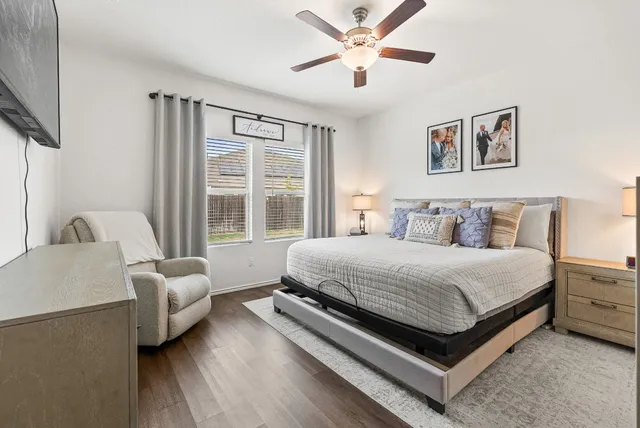 a bedroom with a bed couch and a window