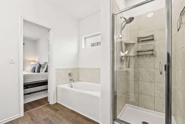 a bathroom with a bathtub and a shower