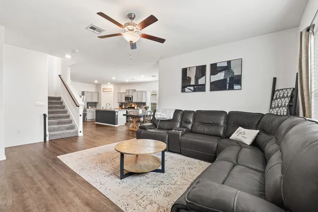 a living room with furniture and wooden floor