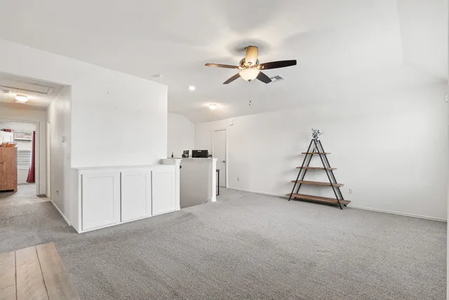 a view of a livingroom with a furniture and ceiling fan