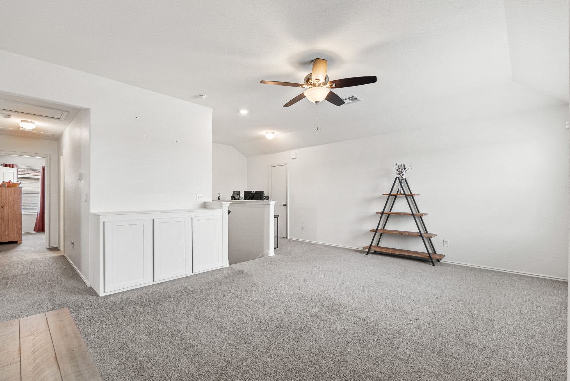 136 Copper Lane Kyle, TX 78640 - Photo 22 of 33 a view of a livingroom with a furniture and ceiling fan