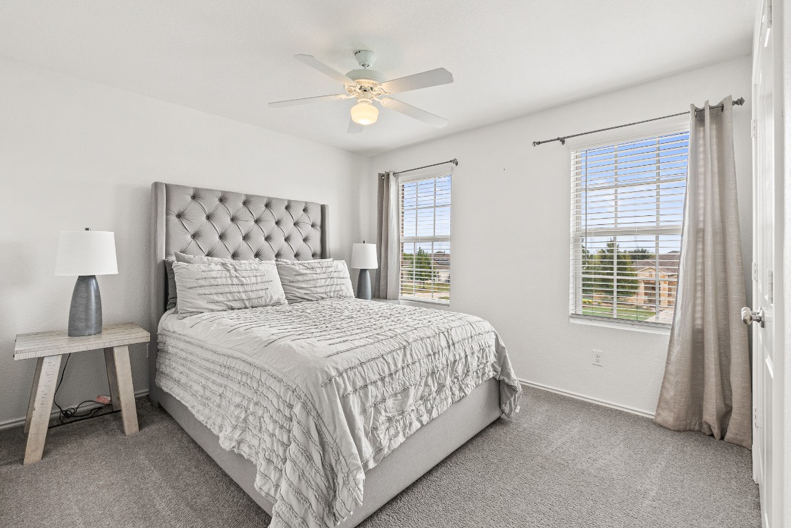 136 Copper Lane Kyle, TX 78640 - Photo 23 of 33 a bedroom with a bed and a window