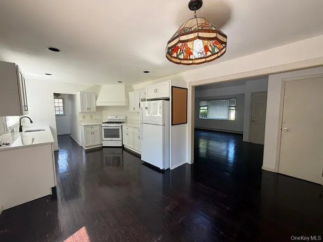 a view of a kitchen center island wooden floor and a kitchen