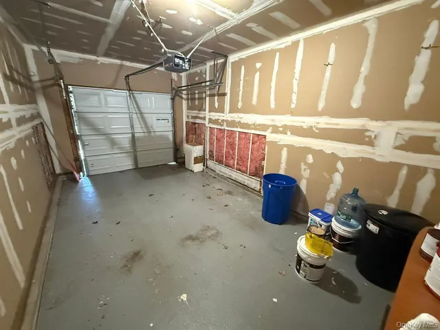 a storage room with water heater and racks