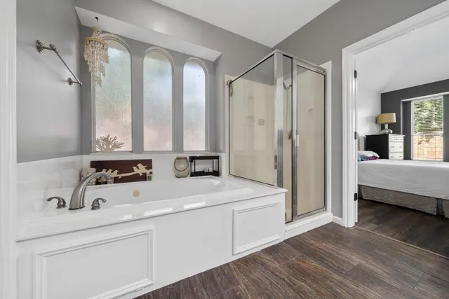 a bathroom with a granite countertop sink and a large mirror