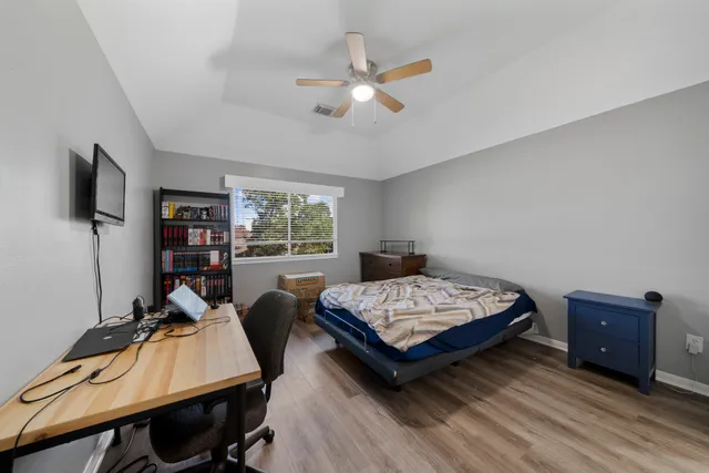 a bedroom with a bed and a chair