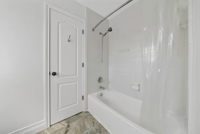 a bathroom with a sink a toilet and shower curtain