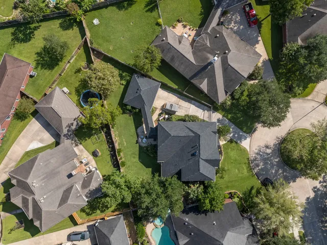 an aerial view of a house with outdoor space