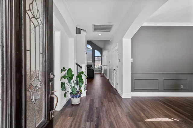 a view of a hallway with wooden floor