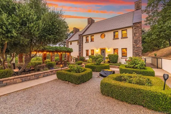 a front view of house with yard and outdoor seating