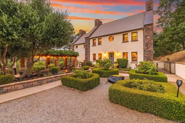a front view of house with yard and outdoor seating