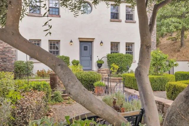 a view of a patio with table and chairs and potted plants