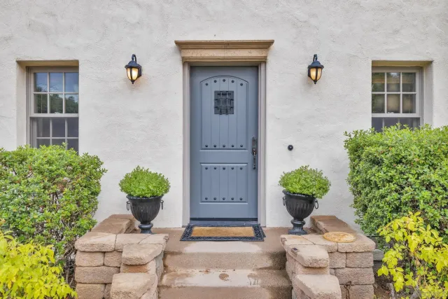 an outdoor sitting area with furniture and a fireplace