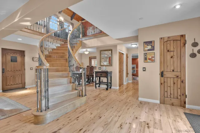a living room with furniture a wooden floor and a chandelier