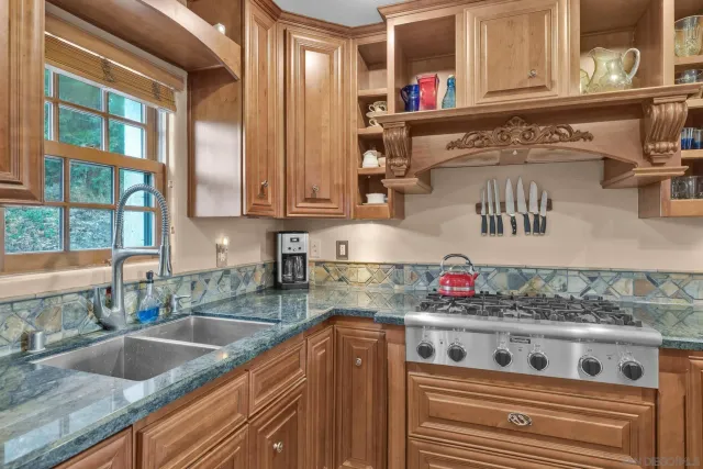 a view of a chair and tables in the back yard of the house