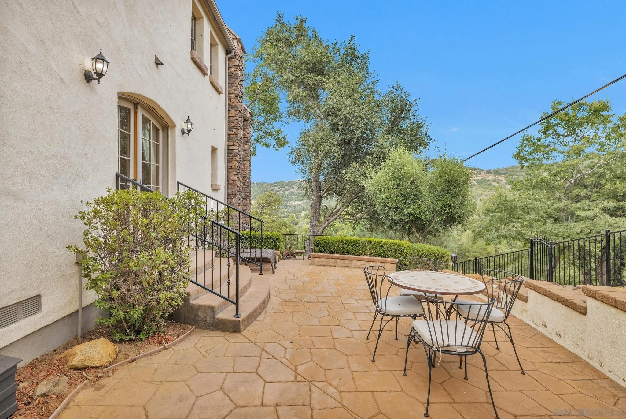 3839 Deer Lake Park Road Julian, CA 92036 - Photo 31 of 74 a view of a patio with a table and chairs and potted plants
