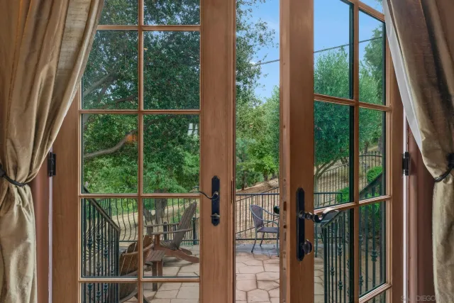 a living room with furniture a rug a fireplace and a large window