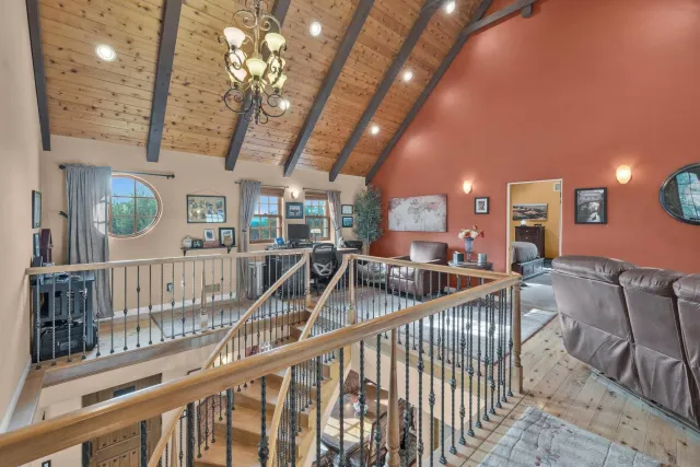 a bedroom with bed and a flat tv screen on dresser