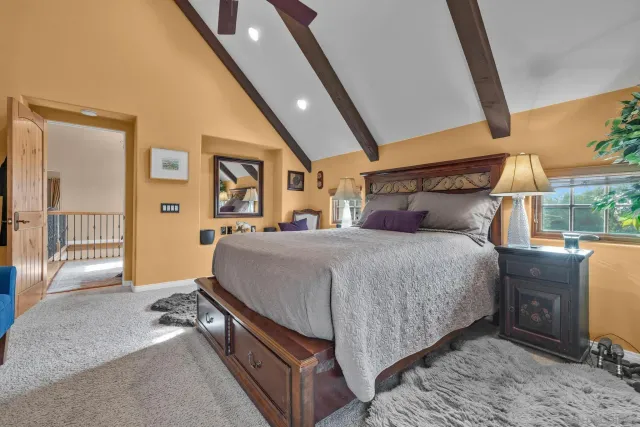 a bathroom with a granite countertop sink a toilet a mirror and shower