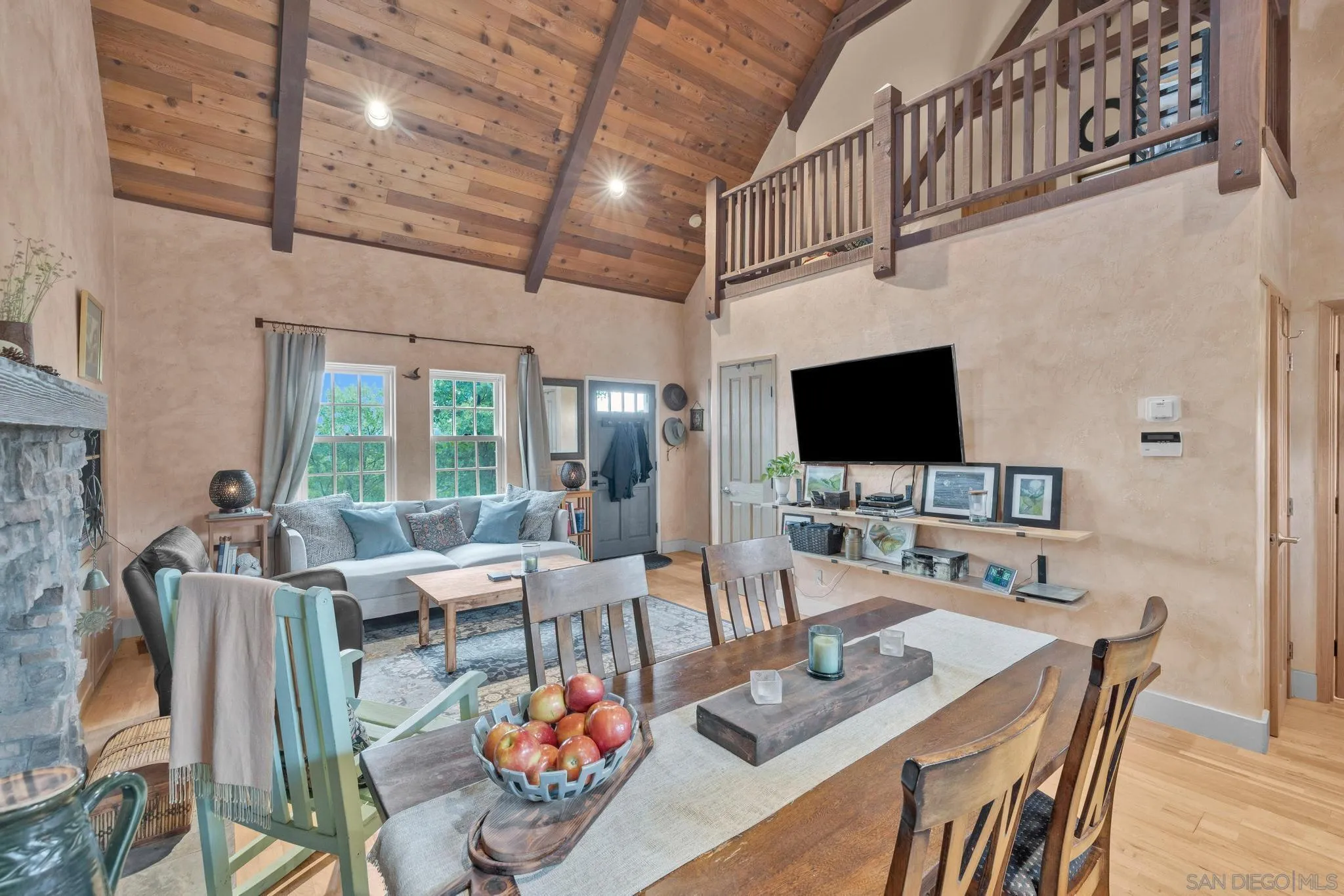 3839 Deer Lake Park Road Julian, CA 92036 - Photo 59 of 74 a living room with furniture a flat screen tv and a floor to ceiling window