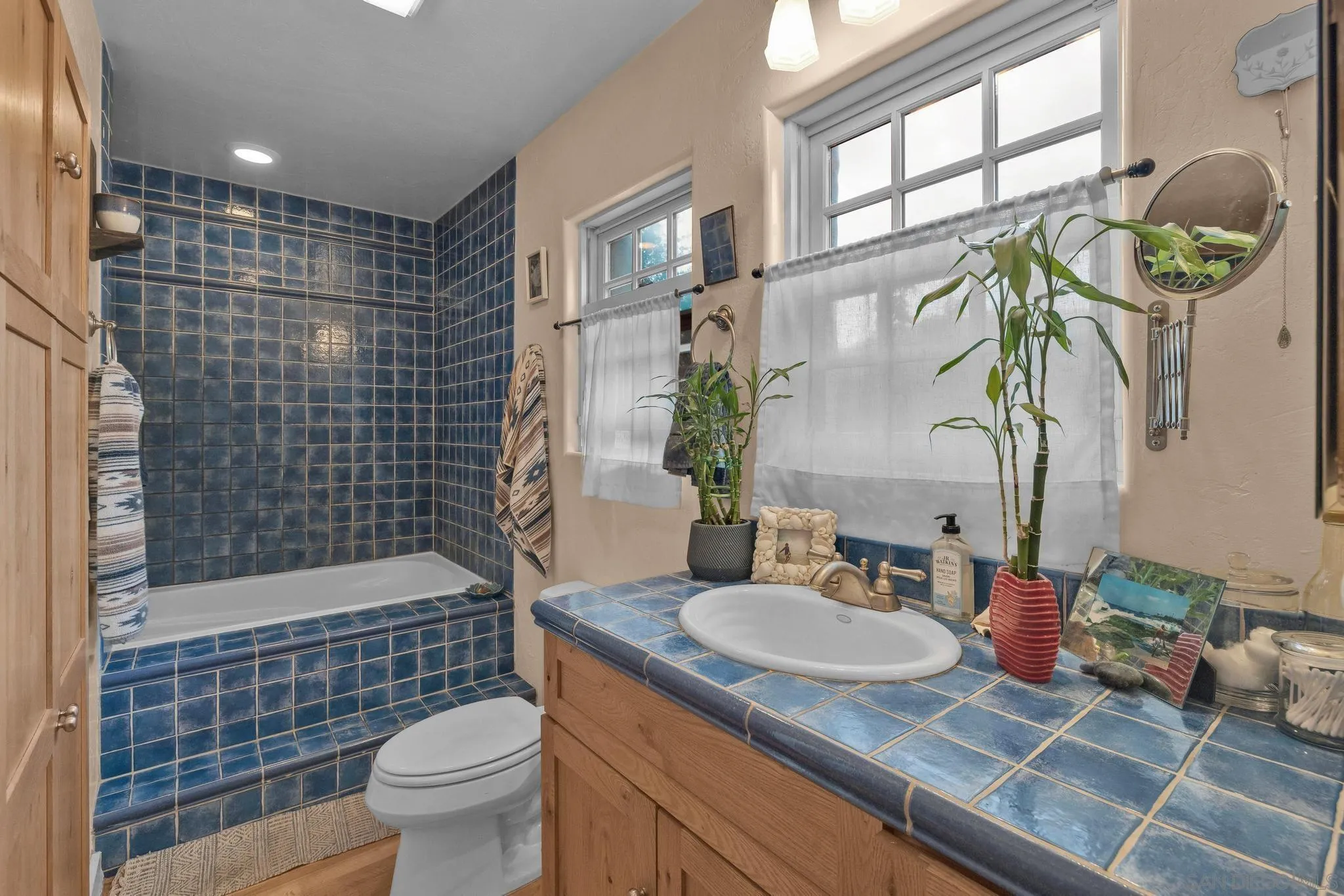 3839 Deer Lake Park Road Julian, CA 92036 - Photo 67 of 74 a bathroom with a granite countertop sink a toilet a mirror and shower