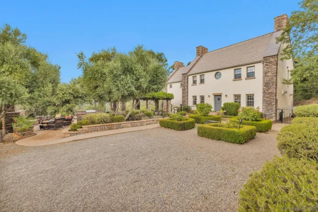a front view of a house with garden