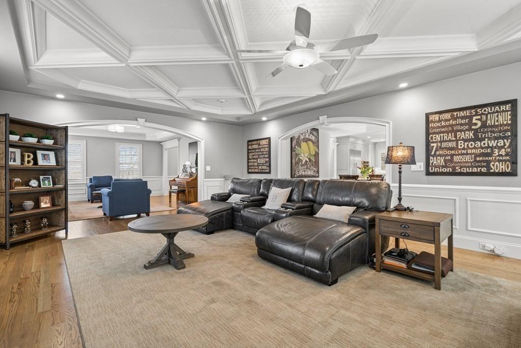 6 Johnson Road Winchester, MA 01890 - Photo 13 of 42 a living room with furniture a chandelier and a flat screen tv
