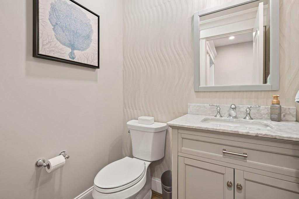 6 Johnson Road Winchester, MA 01890 - Photo 17 of 42 a bathroom with a granite countertop toilet a sink and mirror