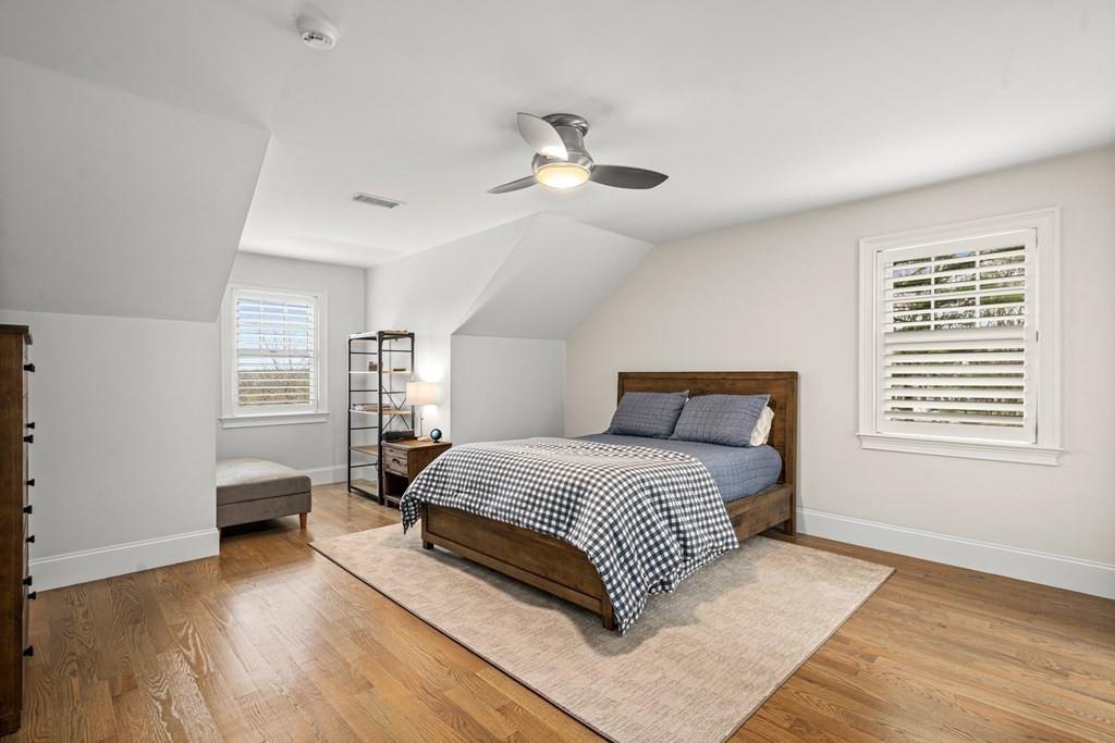 6 Johnson Road Winchester, MA 01890 - Photo 30 of 42 a bedroom with a large bed chandelier and a window