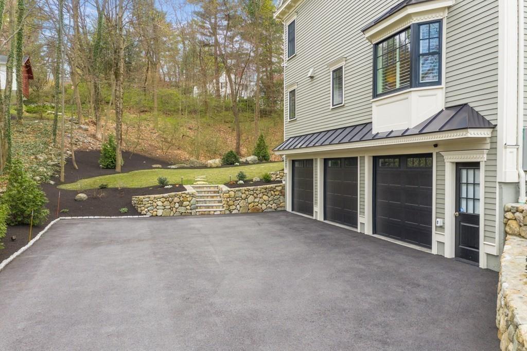 6 Johnson Road Winchester, MA 01890 - Photo 42 of 42 a view of a house with a garden and pathway