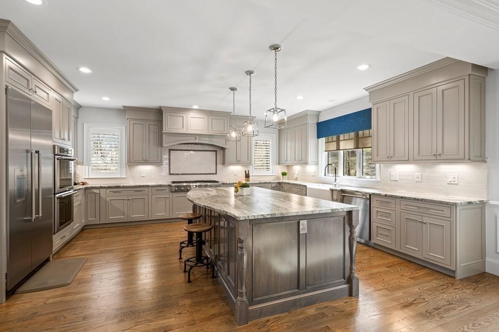 6 Johnson Road Winchester, MA 01890 - Photo 6 of 42 a kitchen with stainless steel appliances granite countertop a sink a stove and a refrigerator
