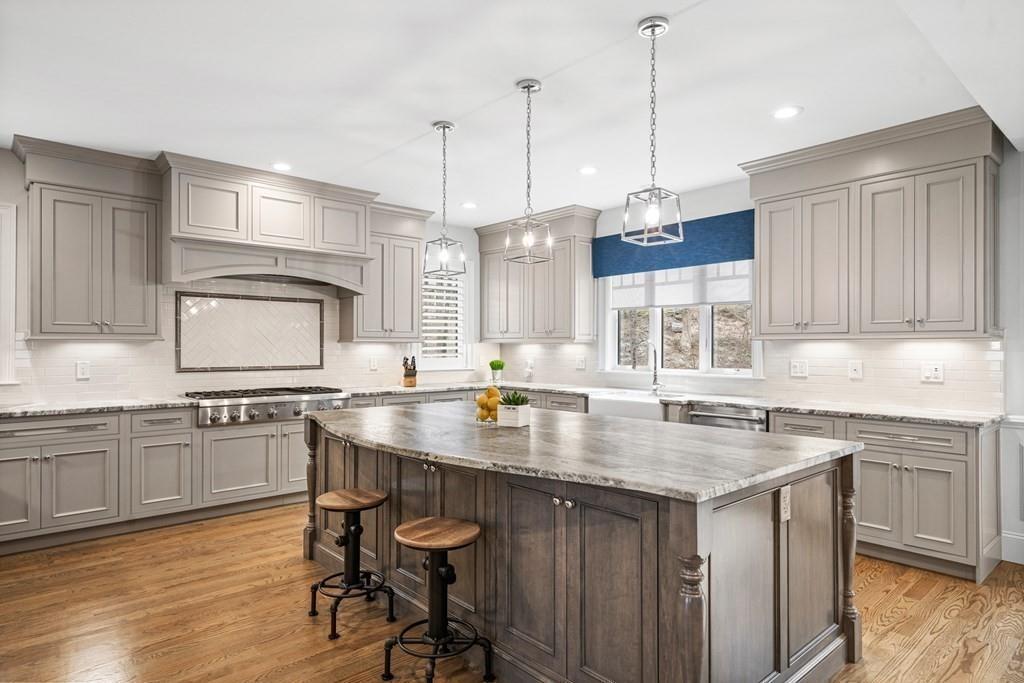 6 Johnson Road Winchester, MA 01890 - Photo 7 of 42 a kitchen with center island appliances and wooden floor