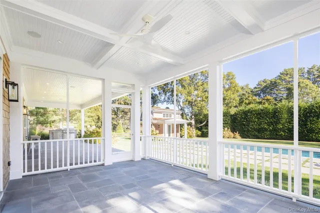 a view of porch with a floor to ceiling window and wooden floor