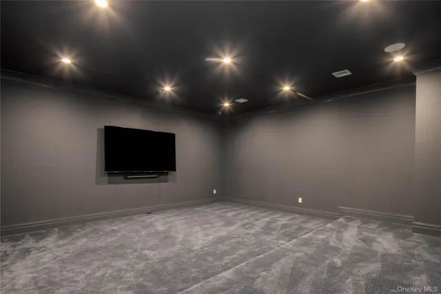 a living room with projector and a flat screen tv