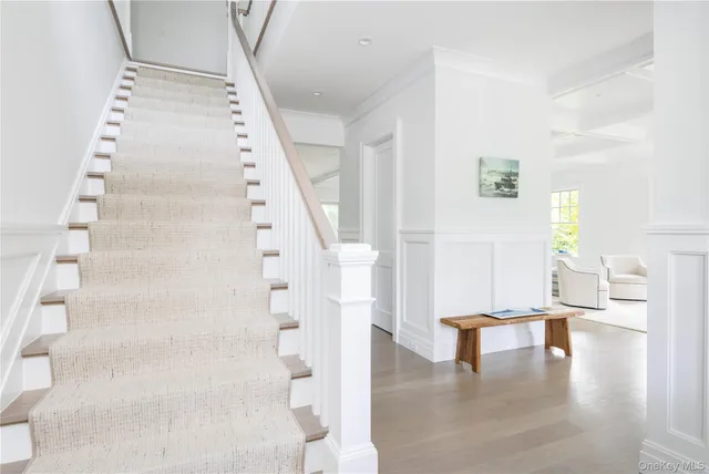 a view of entryway and hall with wooden floor