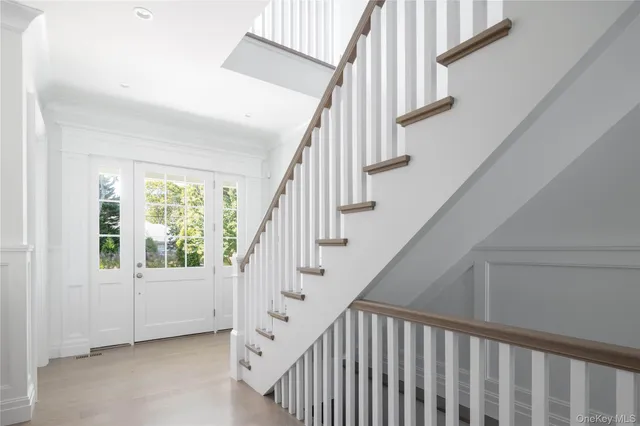 a view of staircase with white walls and a window