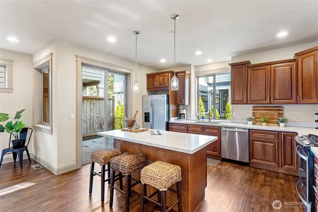 a large kitchen with a table and chairs in it