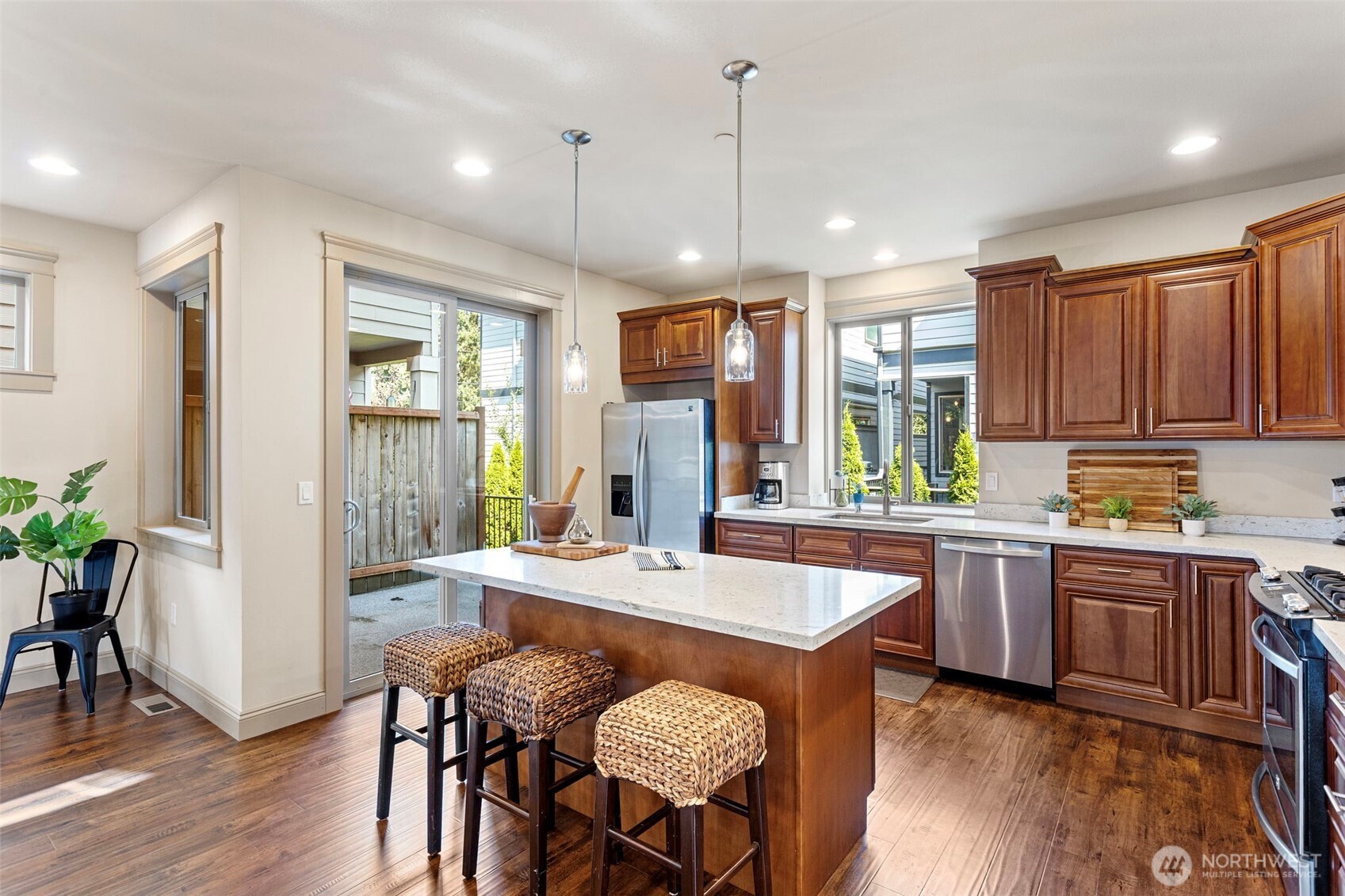 553 Southeast Andrews Street, Unit B Issaquah, WA 98027 - Photo 11 of 28 a large kitchen with a table and chairs in it