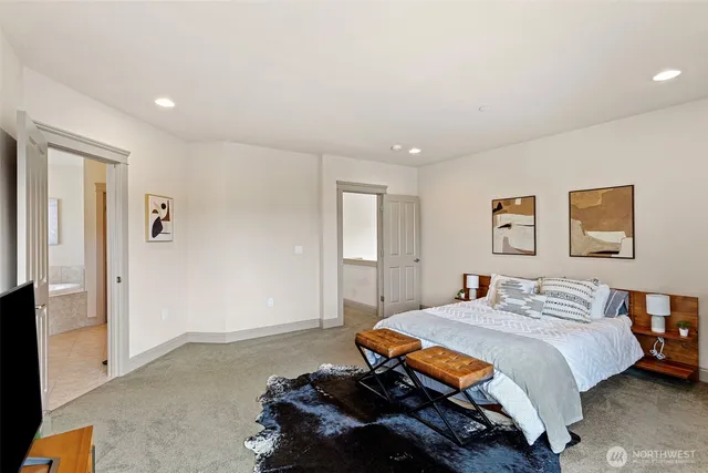 a bedroom with a bed and a painting on the wall