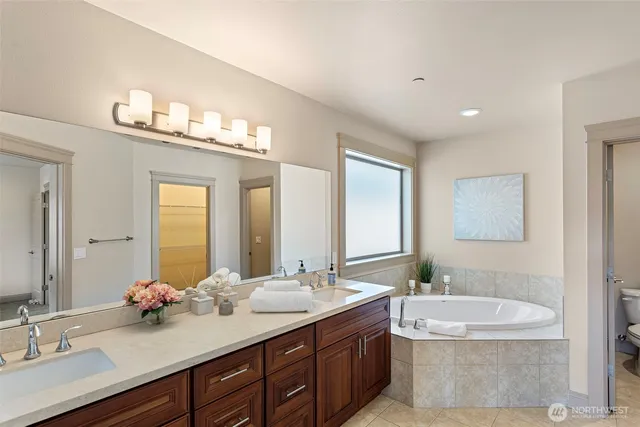 a bathroom with a double vanity sink and a mirror