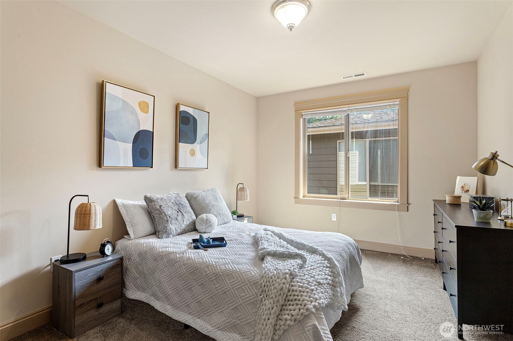 553 Southeast Andrews Street, Unit B Issaquah, WA 98027 - Photo 23 of 28 a bedroom with a bed and wooden floor