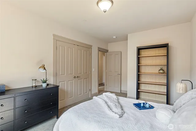 a bedroom with a bed and a dresser