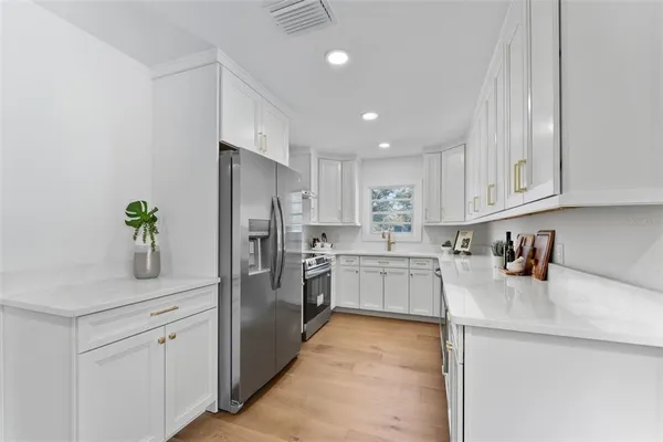 a kitchen with a refrigerator and cabinets