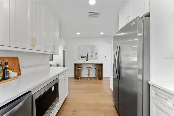 a kitchen with a refrigerator and a stove