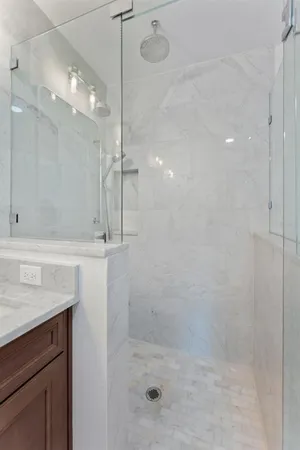a bathroom with a shower sink and mirror